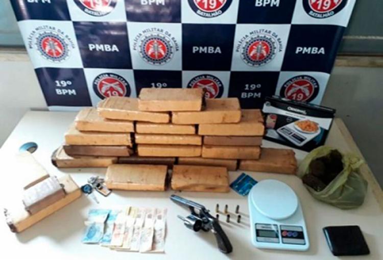 Foram apreendidos 21 tabletes de maconha e um revólver (Foto: Reprodução | Itamaraju Notícias)
