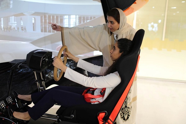 Jovem faz aula de direção em um simulador, sob orientações de uma instrutora feminina em autoescola de Dhahran, na Arábia Saudita (Foto: Ahmed Jadallah | Reuters)